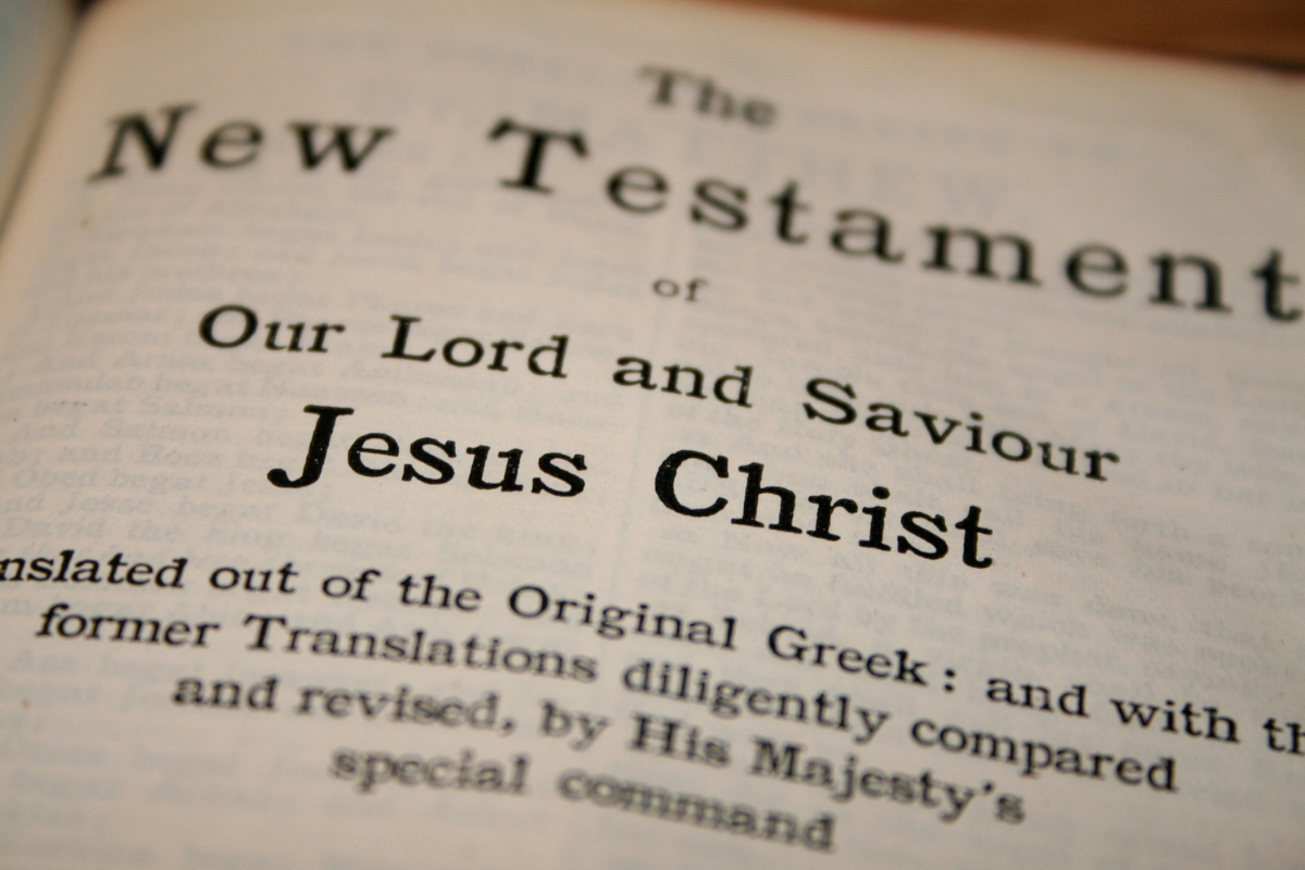 A close-up image of a Bible page, showing the title and introduction of the New Testament section.