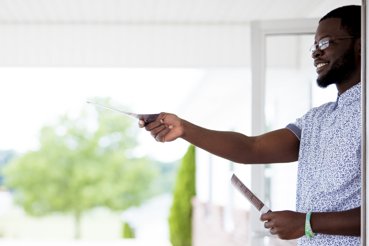 A man handing out pamphlets.