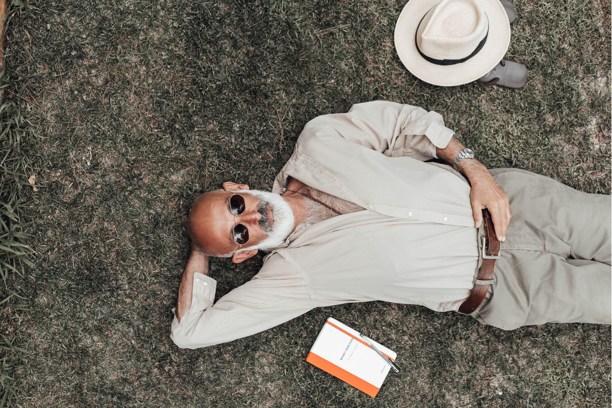 A man lying on the grass resting.