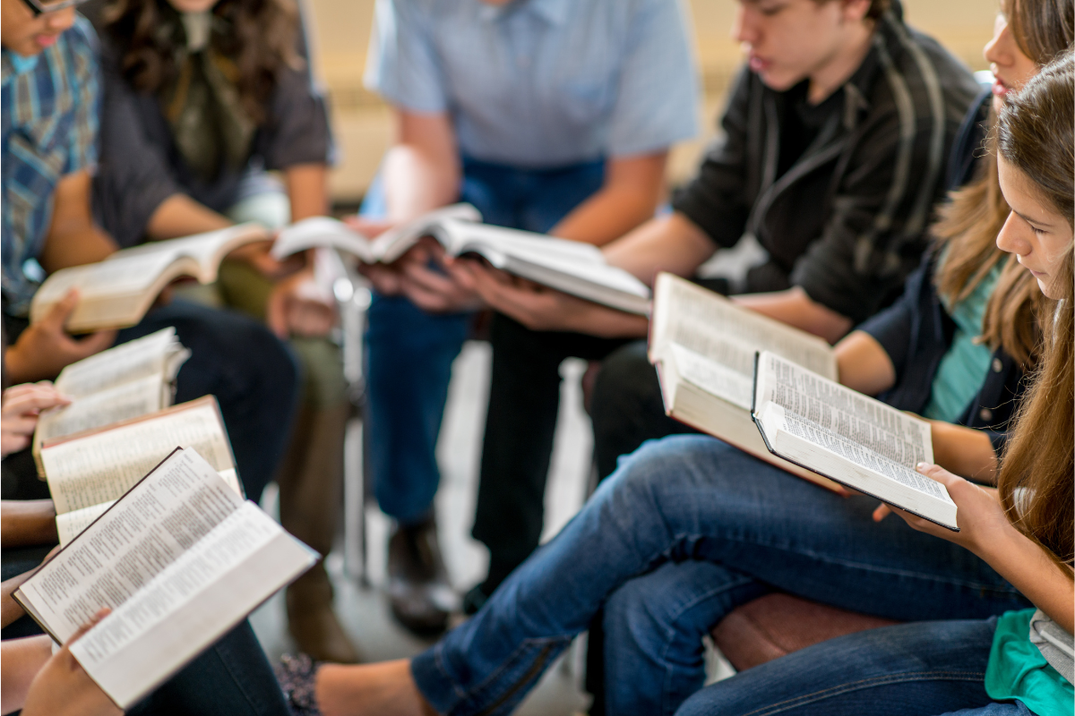 An image of a group of people reading their Bibles.