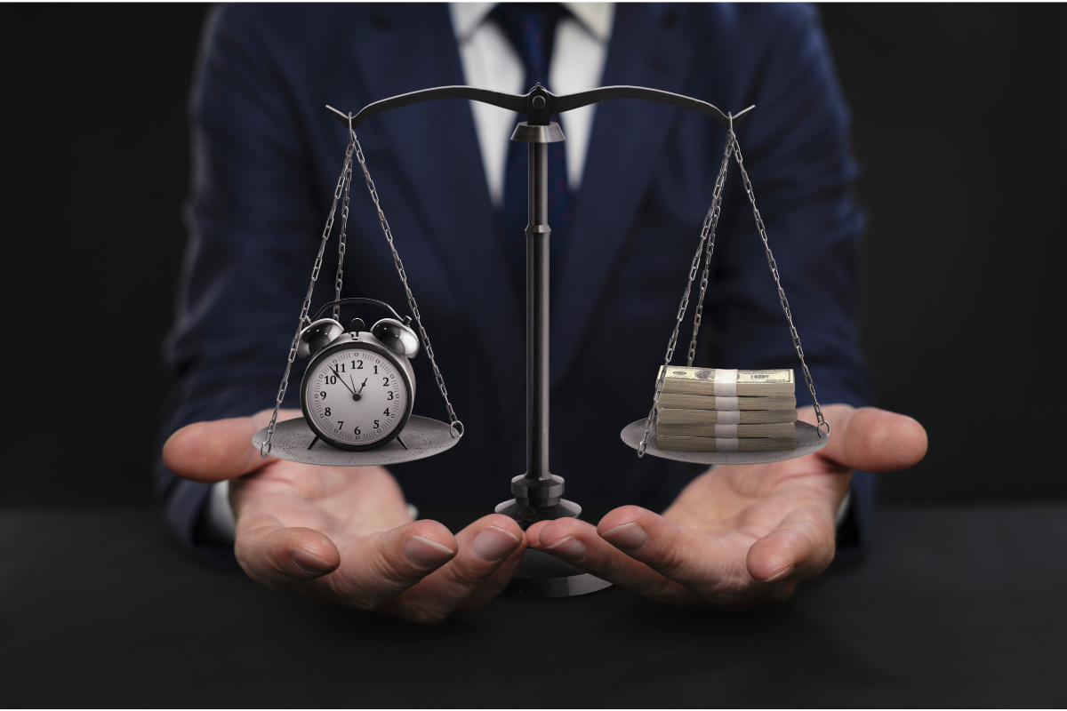 An image of a weighing scale, with a clock on one end, and money on the other.