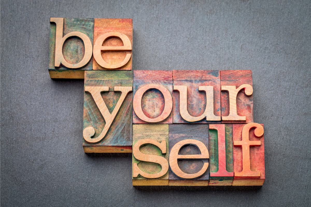 Wooden tiles with the word "be yourself" spelled out.